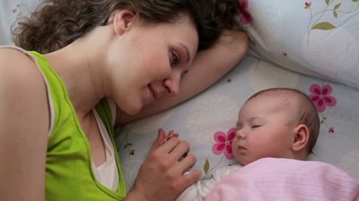 stock footage mom kisses a sleeping baby